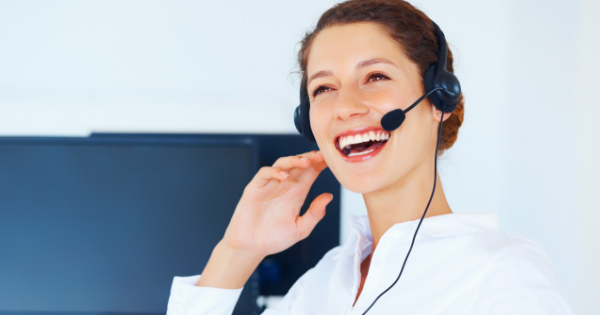 How to Start a Home Based Coaching Business - Whole Family Coaching. Woman on a computer video call wearing a headset.